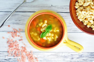 Healthy soup with carrot, peas and chickpea gnocchi