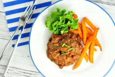 Beef chop on tomatoes with beans